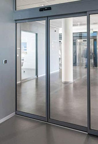 Porta scorrevole - KONE - di radioprotezione / per struttura sanitaria / telescopica